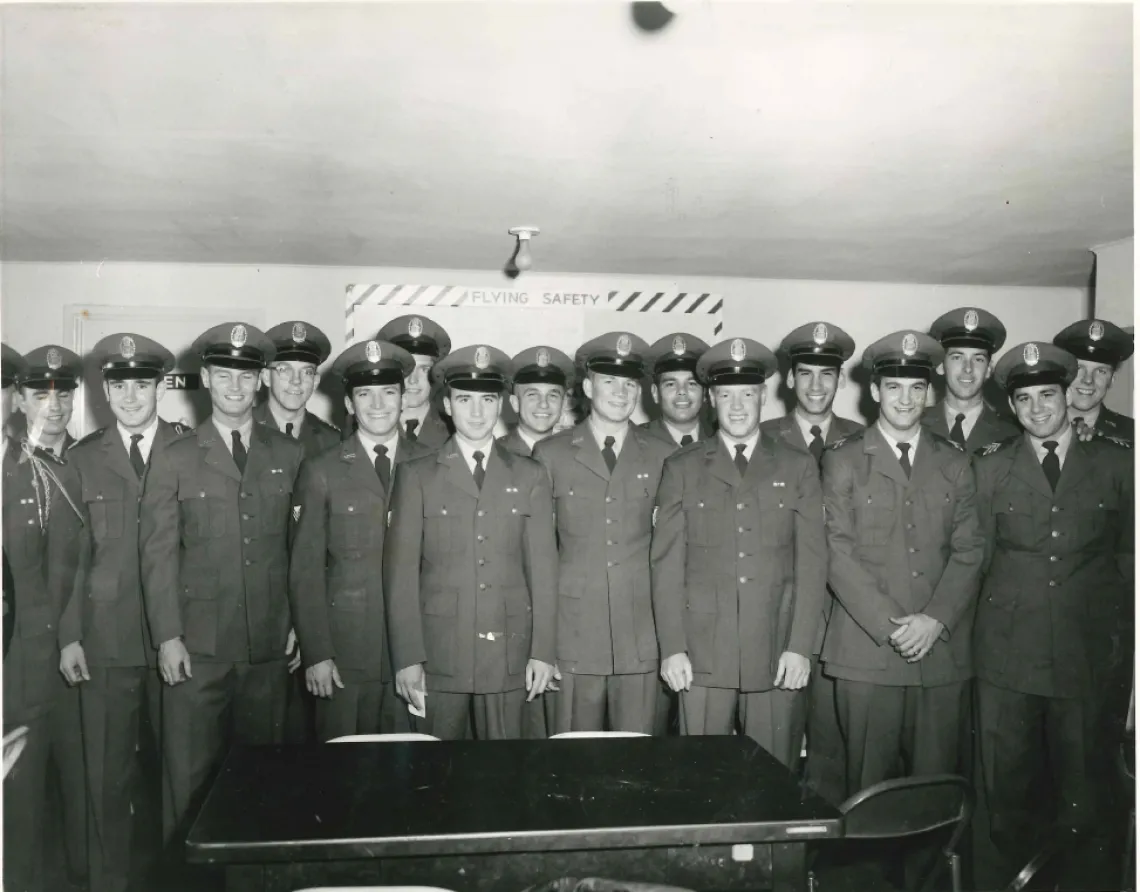 black and white photo of man standing in uniform